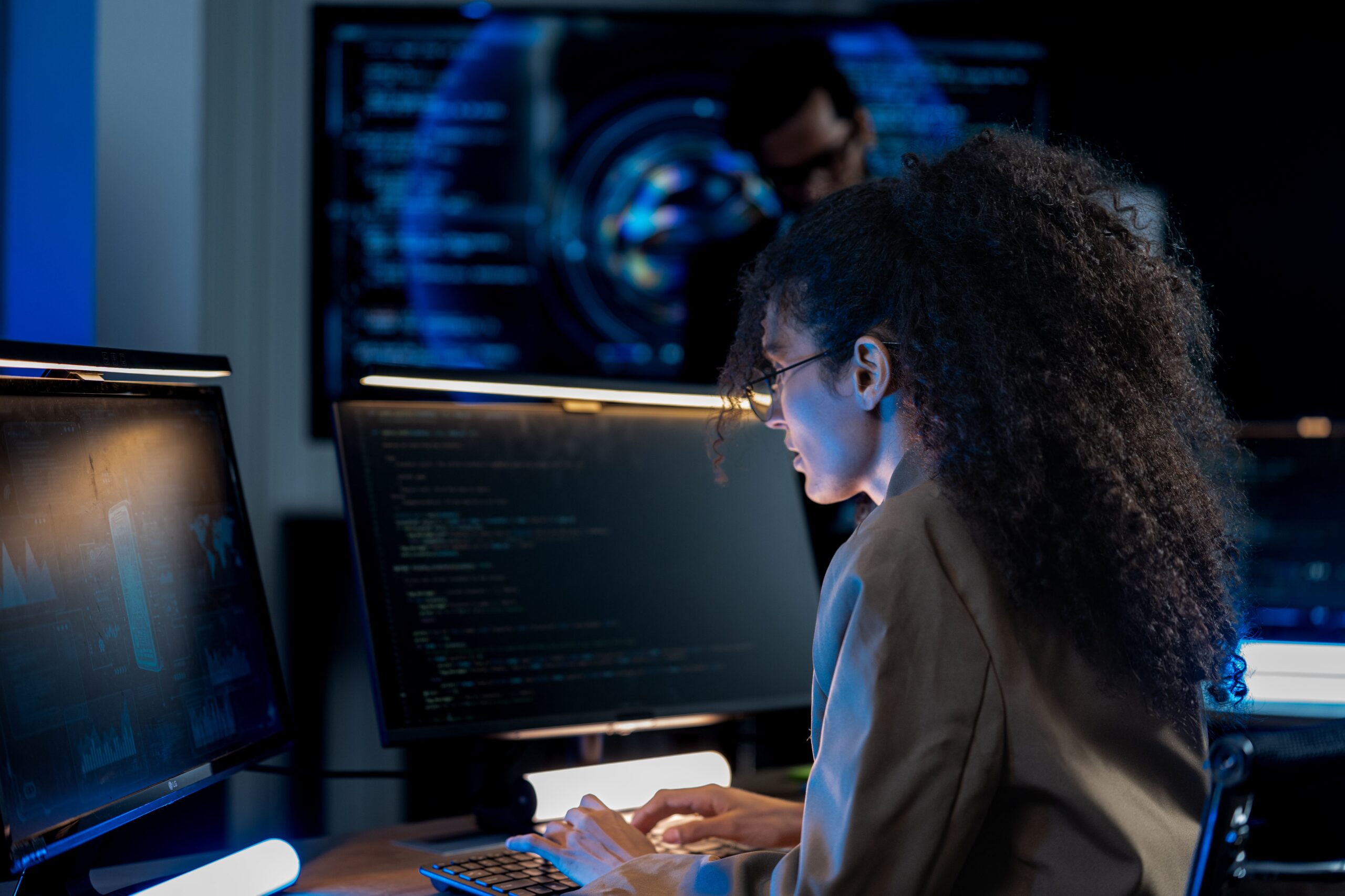 young-woman-focused-on-coding-with-multiple-monito-2026-07-21-17-24-47-utc